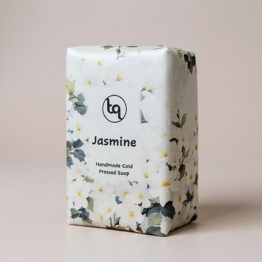 Handmade Jasmine cold pressed soap bar with floral packaging on a beige background