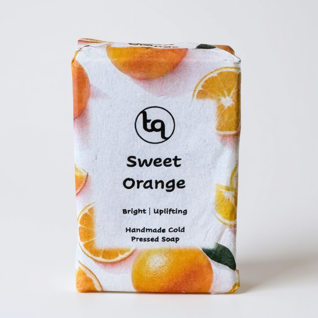 Bar of Truequest soap with orange slices on packaging against a white background
