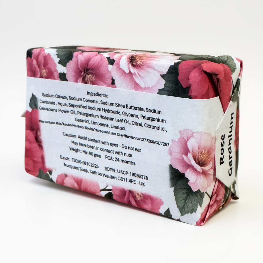Rose geranium bar of soap with floral design and label on a white background