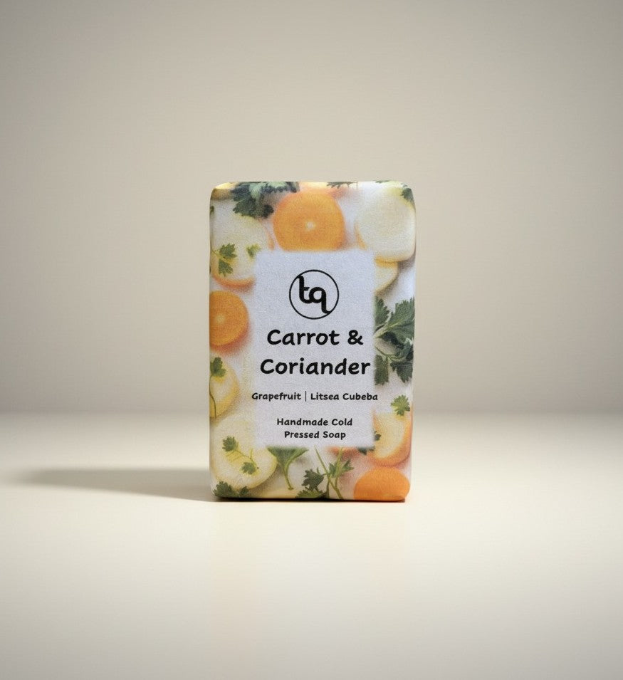 Main product shot of a paper-wrapped Truequest carrot and coriander cold-pressed soap bar