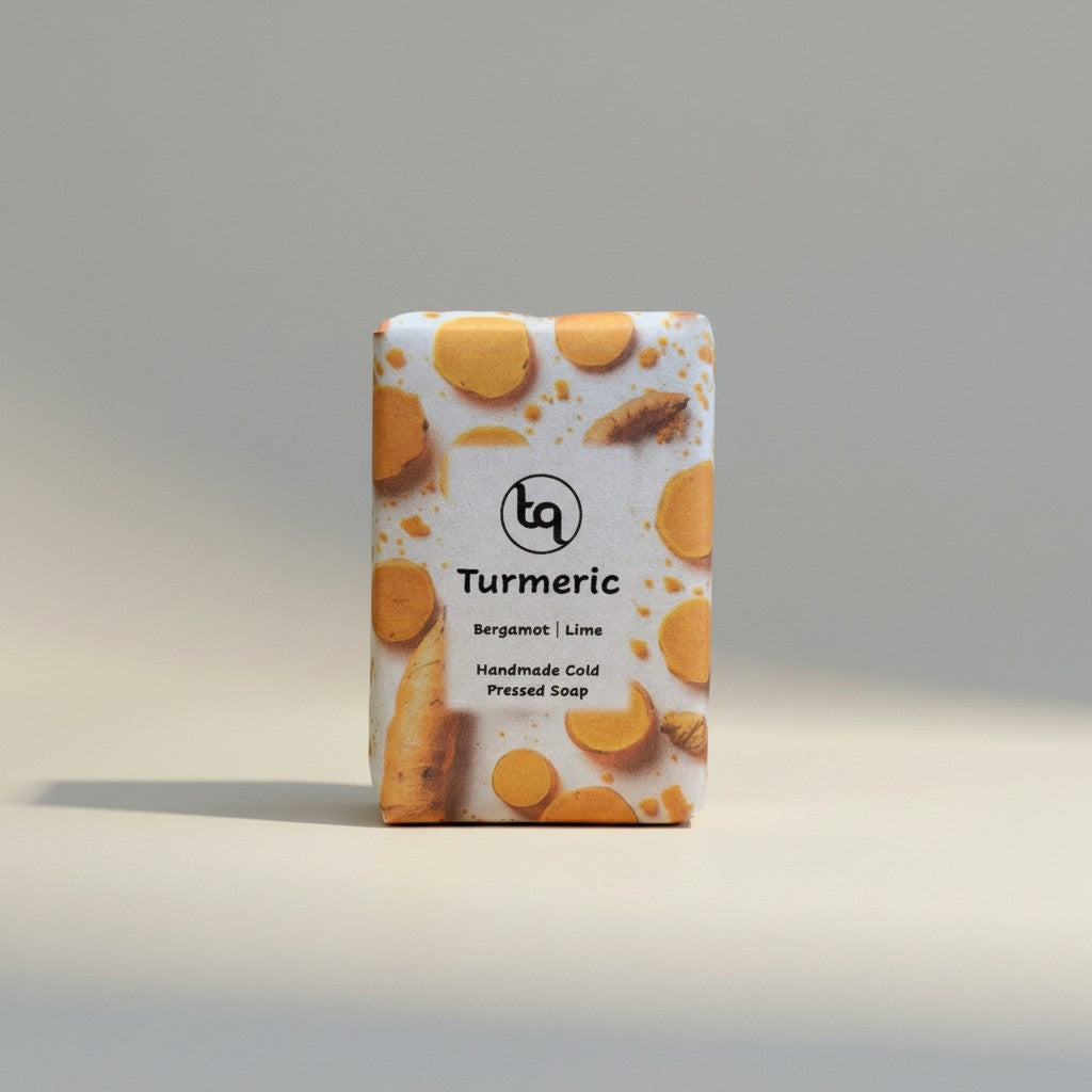 A front-facing product shot of a single rectangular Truequest turmeric cold-pressed soap bar.