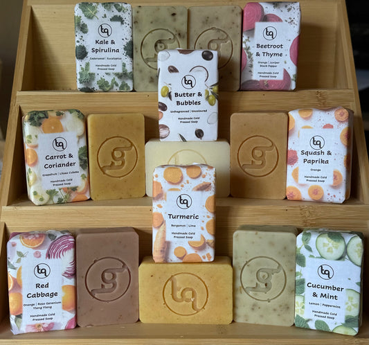 Truequest soap harvest range. Cold pressed soaps in the range in wrappers and unwrapped to show the earth tones and rustic feel