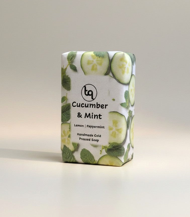 The main product photograph of a Truequest cucumber and mint cold-pressed soap bar, highlighting its fresh, natural coloration and rustic handmade texture on a clean background