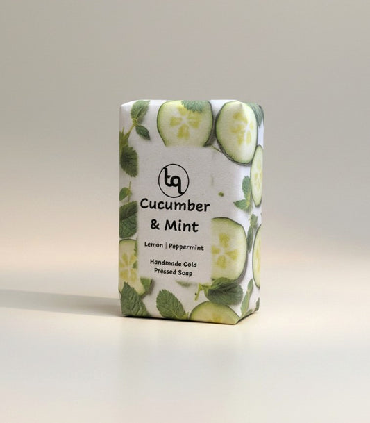 The main product photograph of a Truequest cucumber and mint cold-pressed soap bar, highlighting its fresh, natural coloration and rustic handmade texture on a clean background