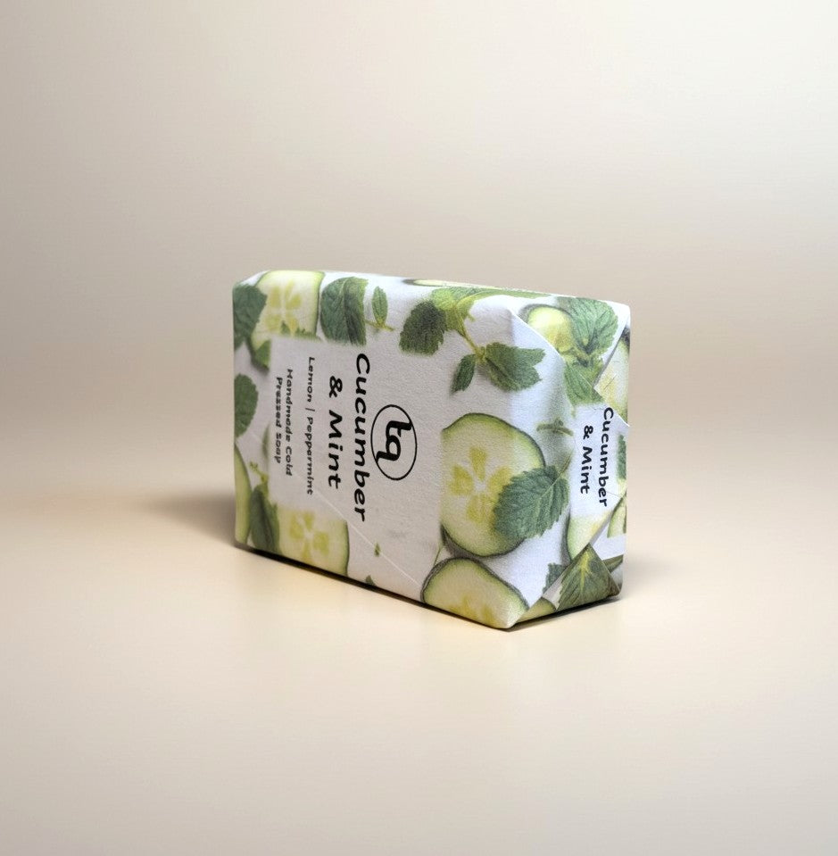 A single rectangular bar of Truequest cucumber and mint cold-pressed soap positioned horizontally on its narrow edge. The side angle emphasizes the depth of the bar