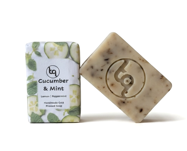 Wrapped and unwrapped Truequest cucumber and mint cold-pressed soaps displayed at an angle.