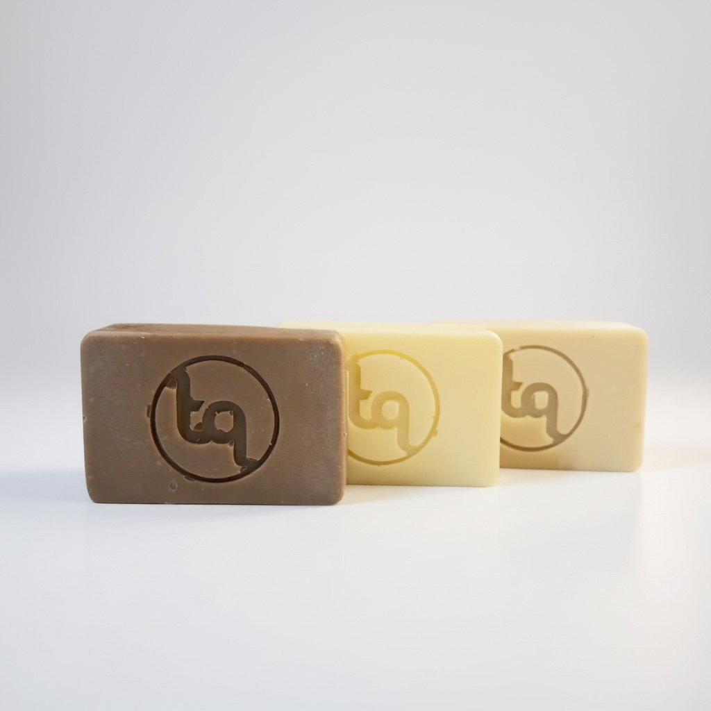 Three bars of soap with a logo on a white background