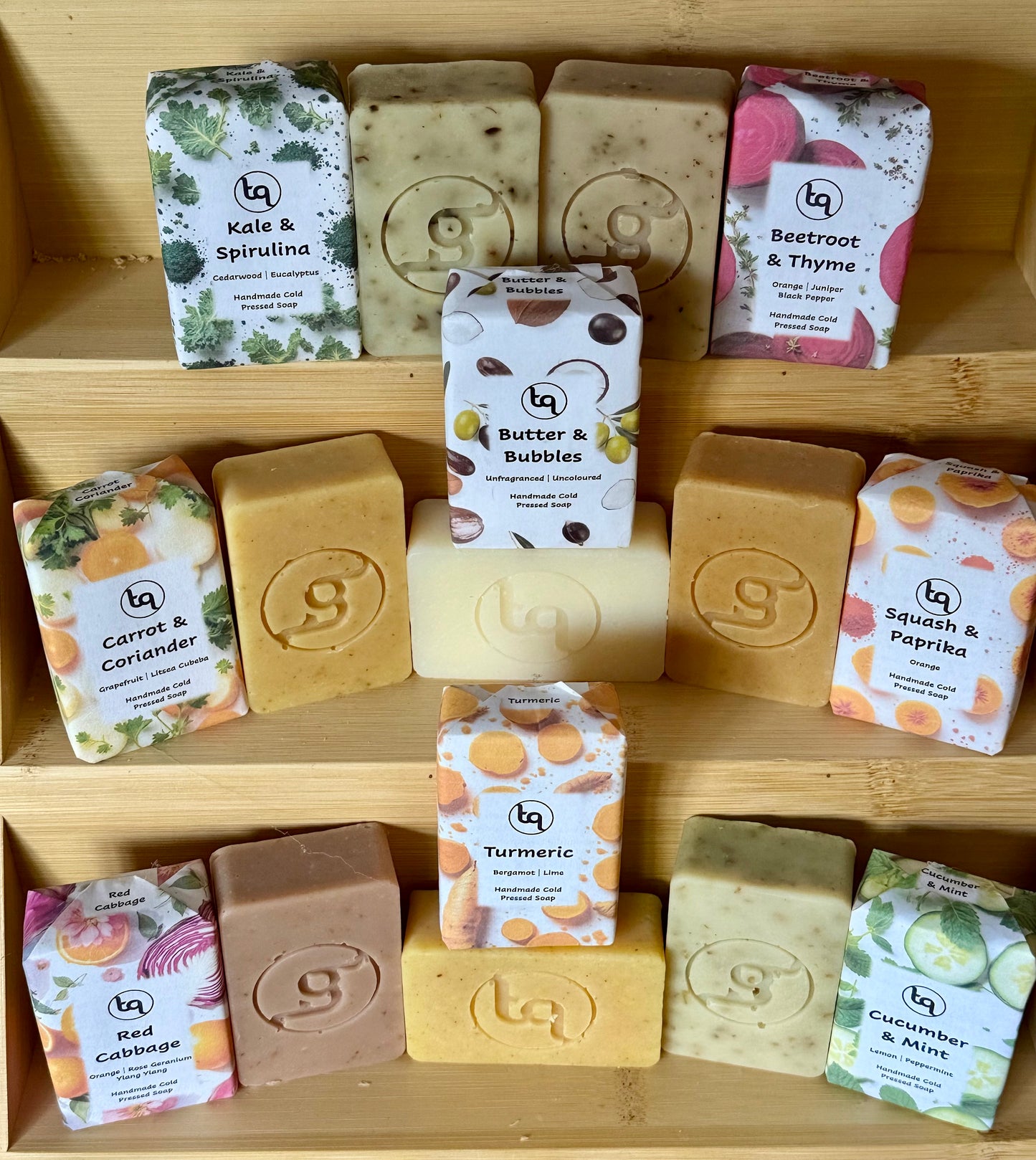 Assorted soaps and packaging on a wooden shelf