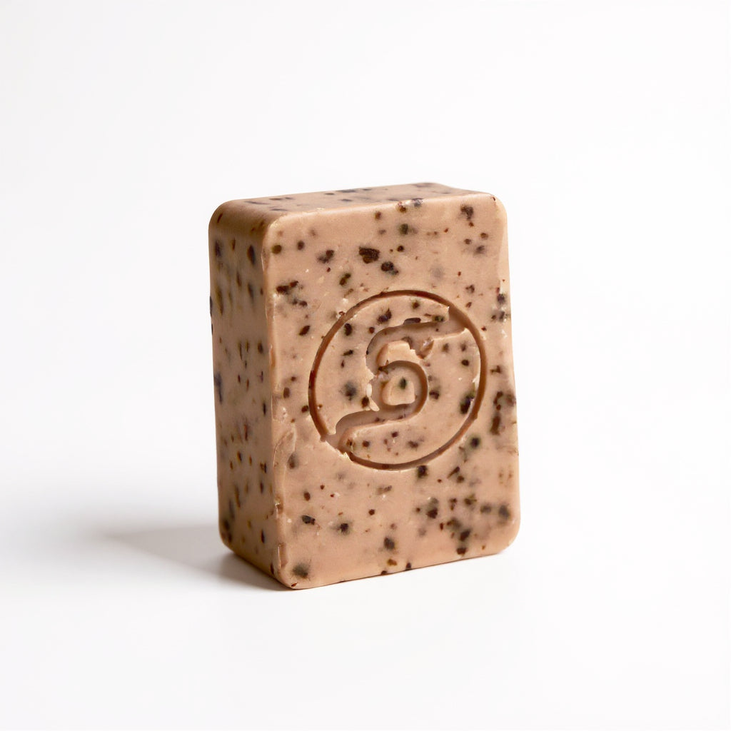 Beetroot, thyme, juniper, black pepper and orange bar of soap with Truequest logo on a white background