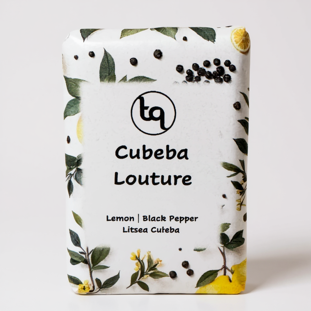 Truequest Cubeba Couture soap wrapped in white paper illustrated with lemon slices, green leaves and black peppercorns.