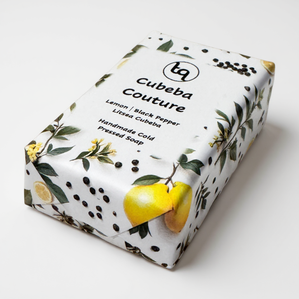 Truequest Cubeba Couture soap wrapped in white paper illustrated with lemons, green leaves and black peppercorns