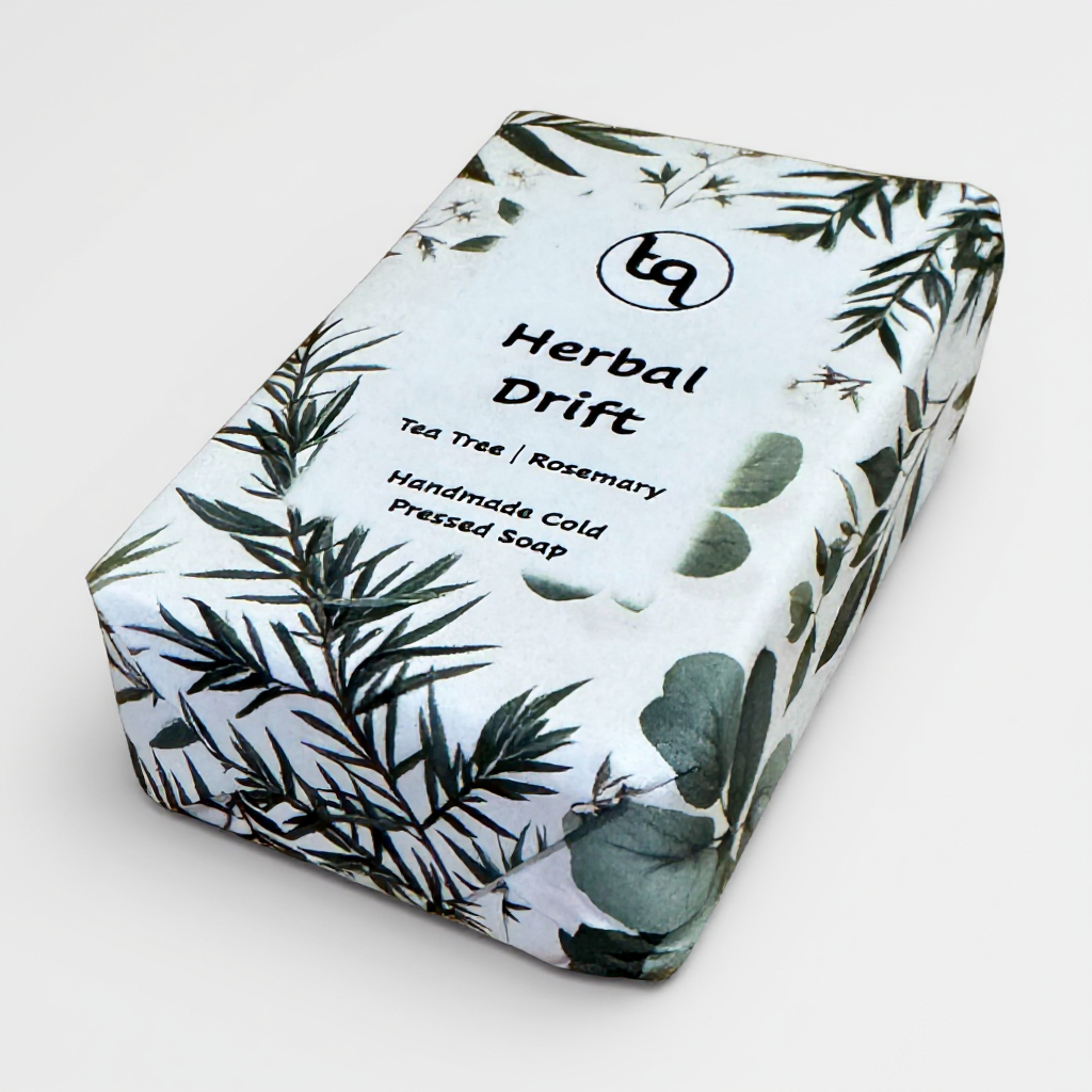 Truequest Herbal Drift cold pressed soap wrapped in white paper with green botanical tea tree and rosemary illustrations.