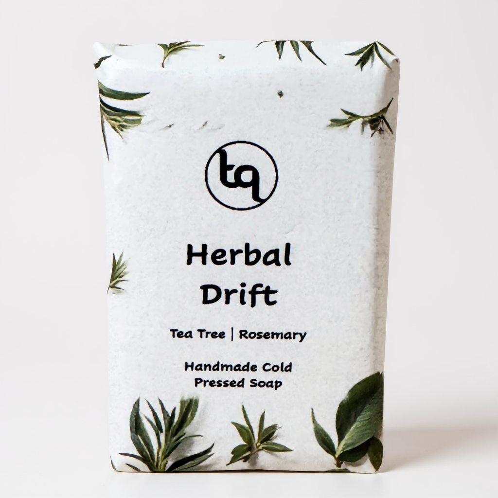 Truequest Herbal Drift cold pressed soap wrapped in white paper with green botanical tea tree and rosemary illustrations.