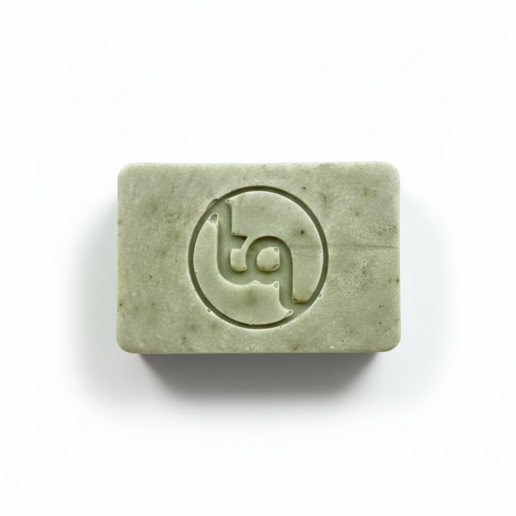 Green bar of soap with Truequest logo on a white background