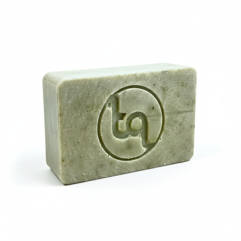 Green bar of soap at an angle with Truequest  logo on a white background
