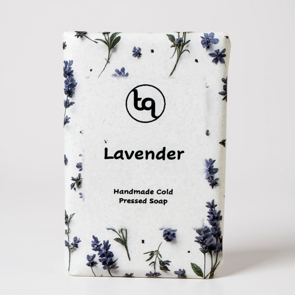 Truequest lavender handmade soap wrapped in white paper decorated with scattered purple flower motifs.