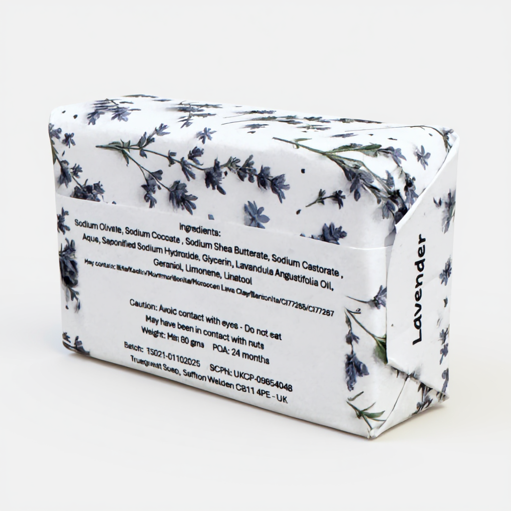 Truequest lavender soap wrapped in white paper with small purple flower illustrations and a vertical scent label, showing the full ingredient list on the back.