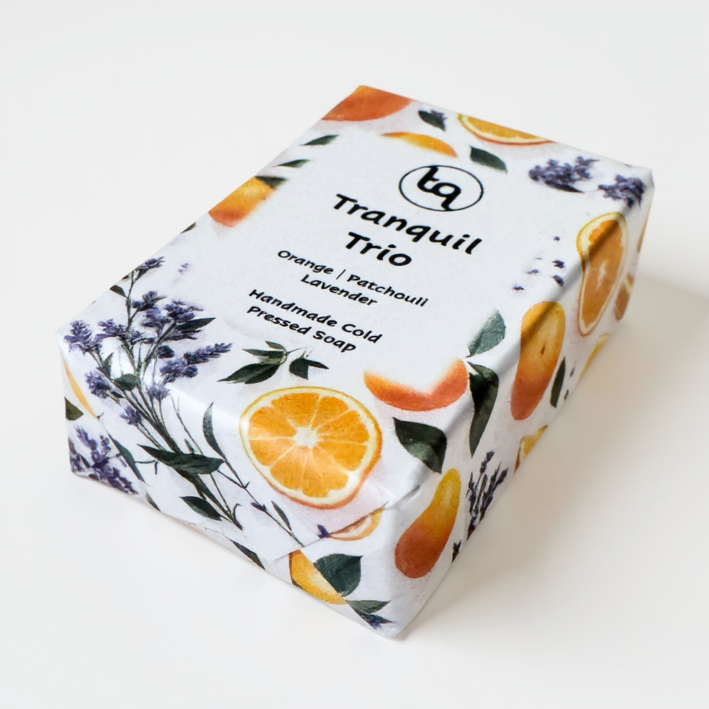 Soap packaging with orange slices and lavender flowers on a white background with TQ logo