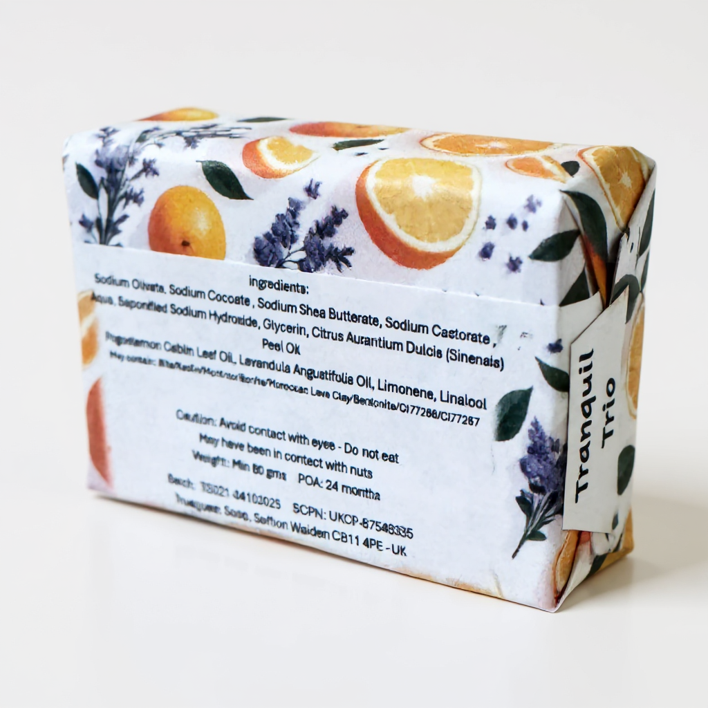 Orange, lavender and patchouli bar of soap with a decorative label featuring oranges and lavender on a white background