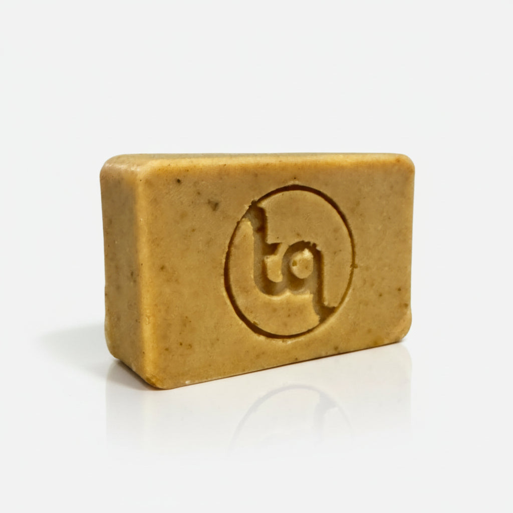 Bar of soap with Truequest 'tq' logo on a white background