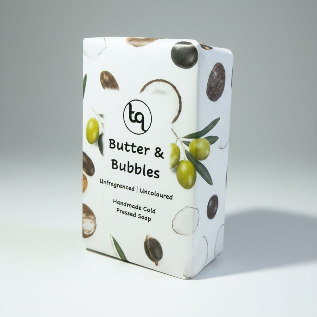 Truequest butter and bubbles soap with coconut,olive, shea and castor oil ingredients design on a gray background