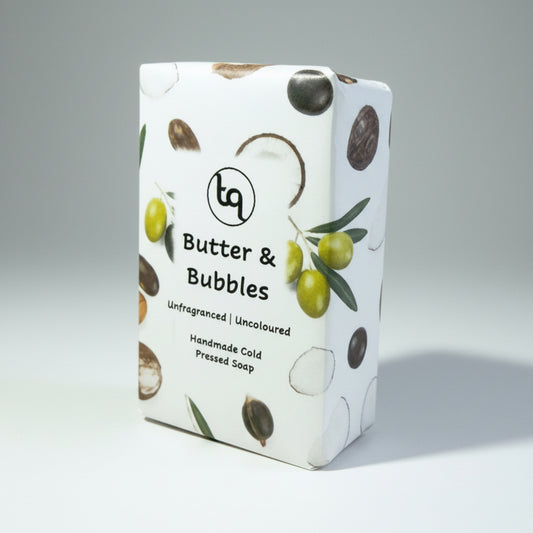 Truequest butter and bubbles soap with coconut,olive, shea and castor oil ingredients design on a gray background