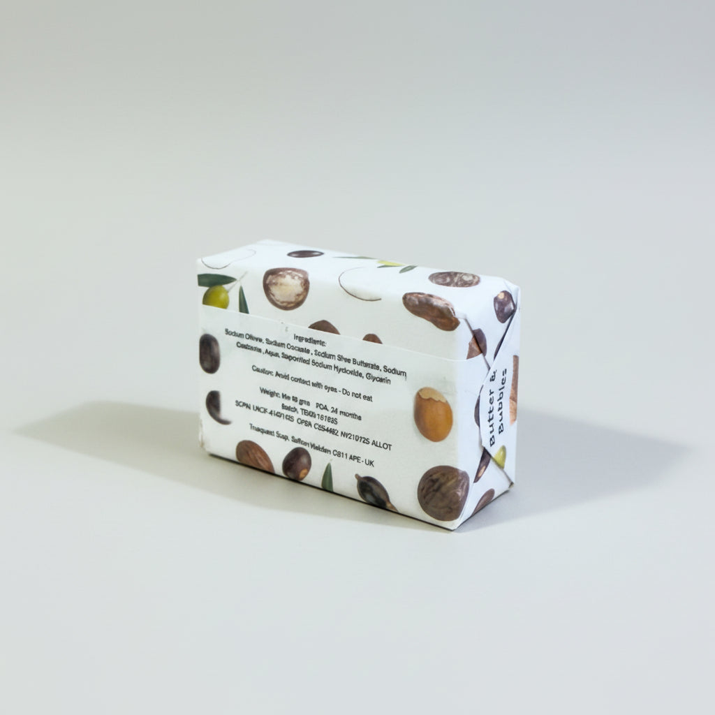 butter and bubbles unfragranced and uncoloured Truquest soap bar on its side displaying the ingredients on a white background